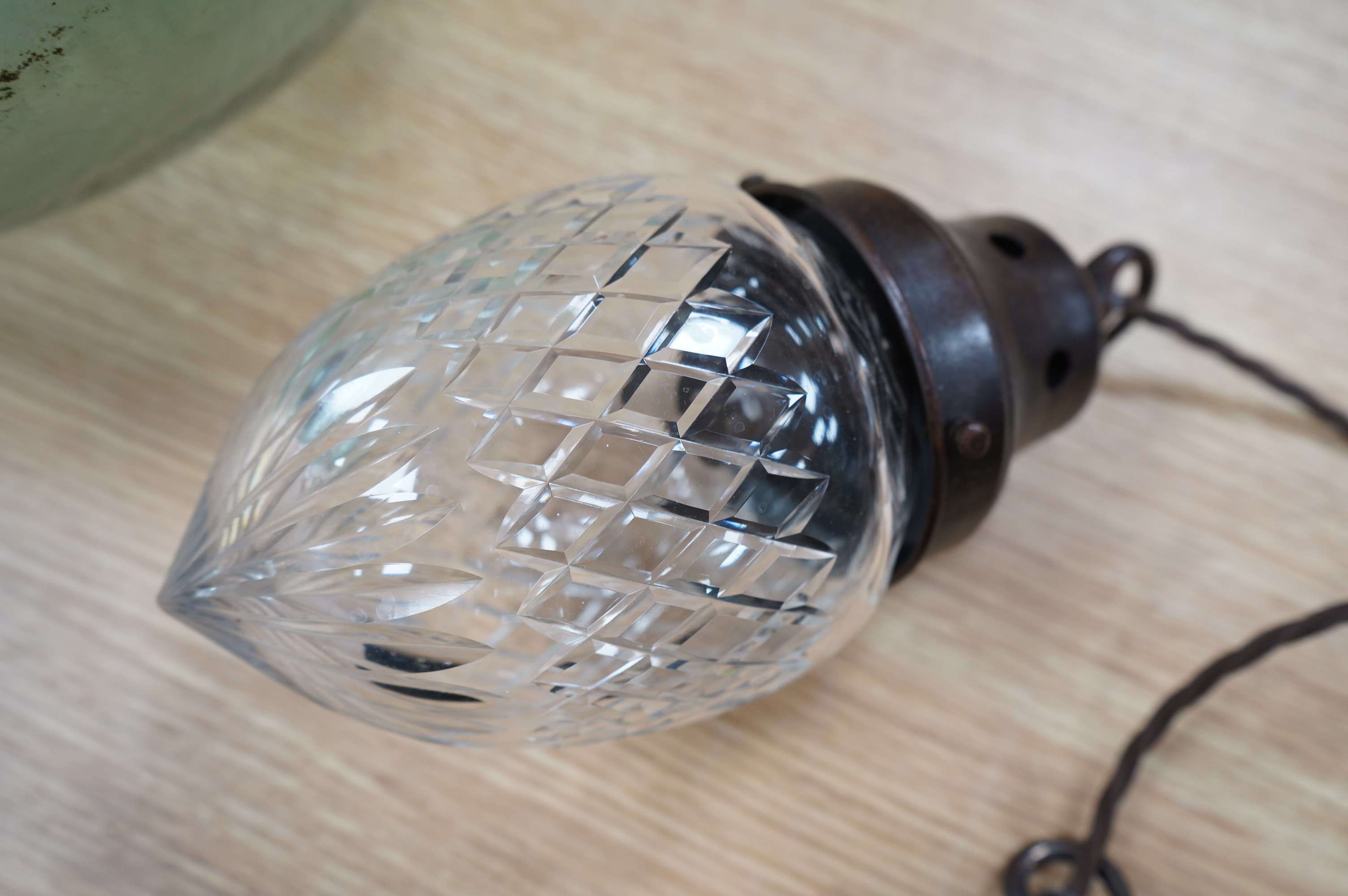 An English 1920’s crystal acorn pendant with gilded bronzed fitting, chain and ceiling rose, wired, glass including gallery 24cm high, 11cm across. Condition - good.